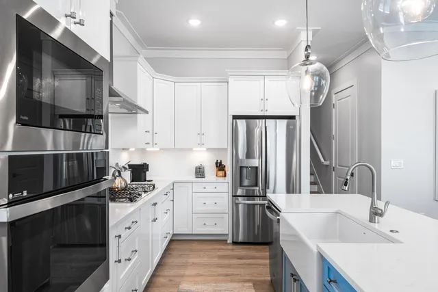 a kitchen with granite countertop a sink stainless steel appliances and cabinets