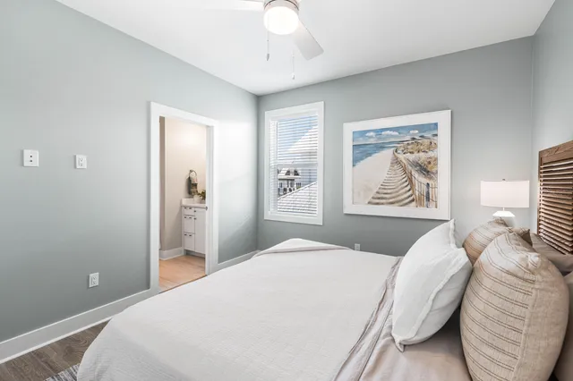 a view of backyard with large trees and wooden fence