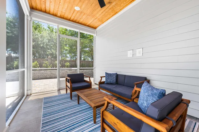 a view of a house with pool and sitting area