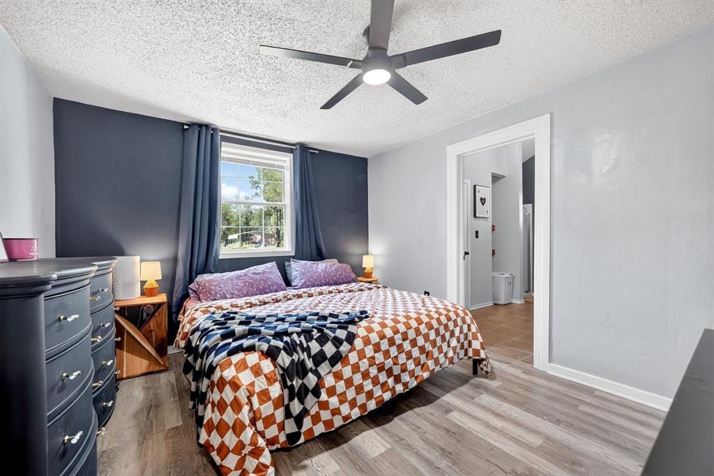 810 Edna Street Athens, TX 75751 - Photo 18 of 28 Spacious room featuring wood-finish flooring, a ceiling fan with integrated lighting, and a window with a white frame