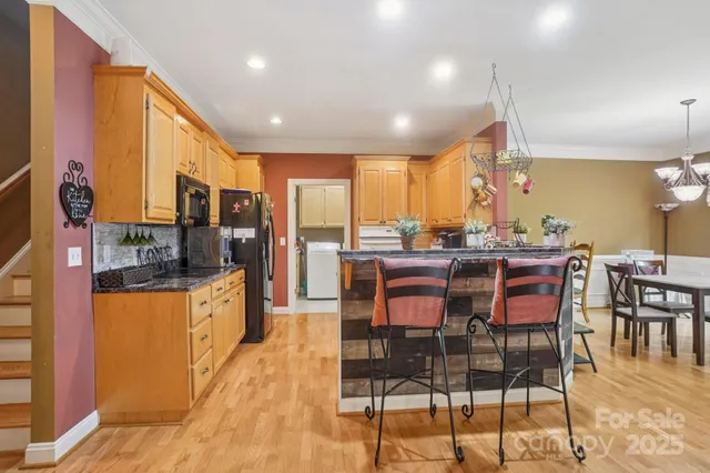 a large kitchen with a table and chairs