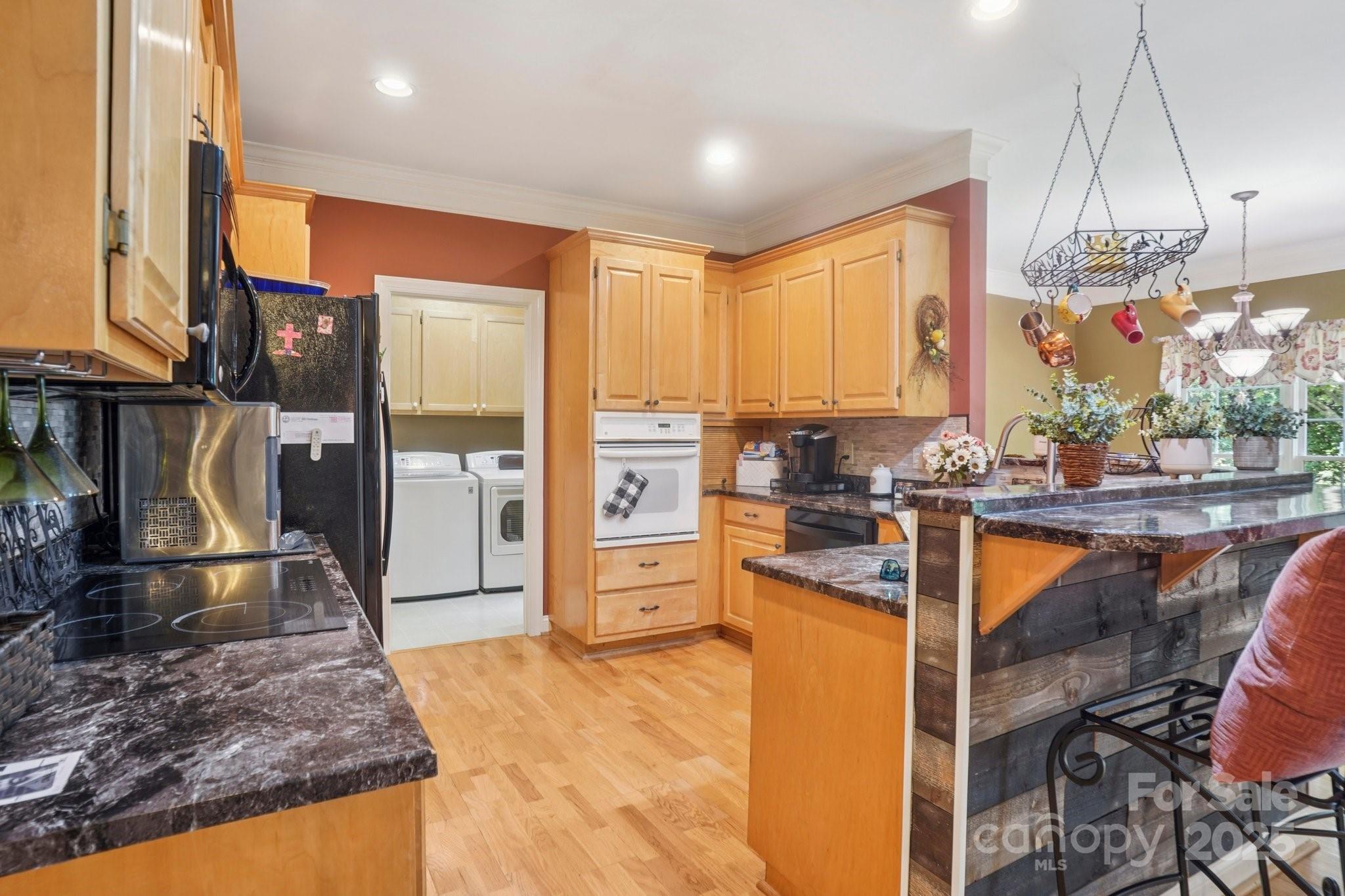 105 Berea Baptist Church Road Stanfield, NC 28163 - Photo 12 of 48 a kitchen with stainless steel appliances granite countertop a refrigerator and a sink