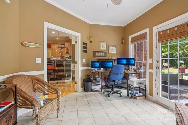 a view of a livingroom with workspace and a window