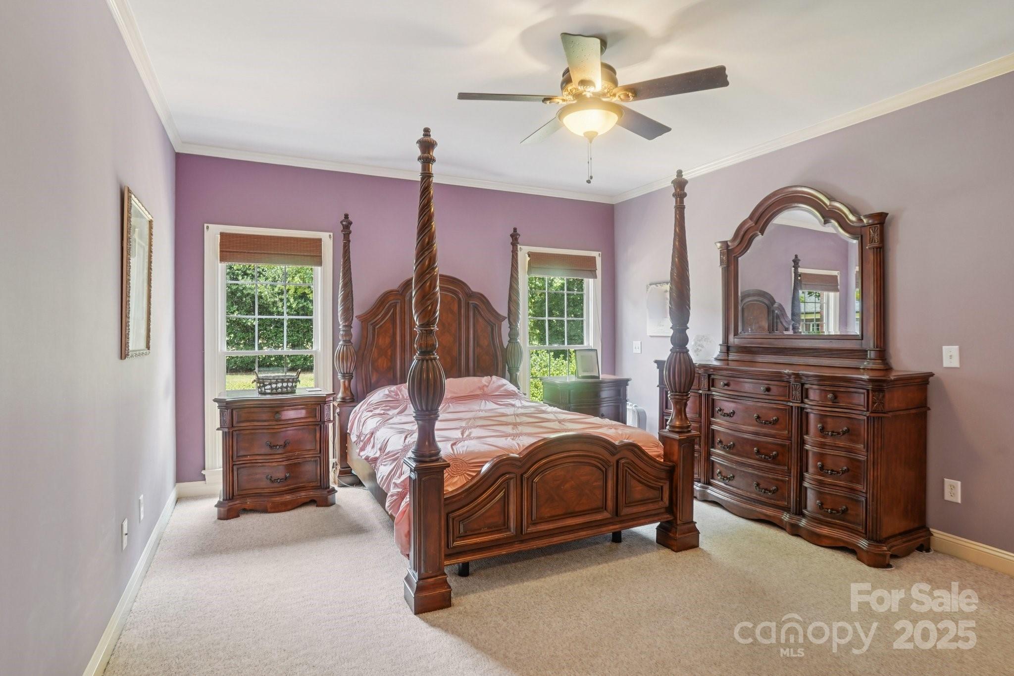 105 Berea Baptist Church Road Stanfield, NC 28163 - Photo 19 of 48 a bedroom with a bed a chandelier and dresser