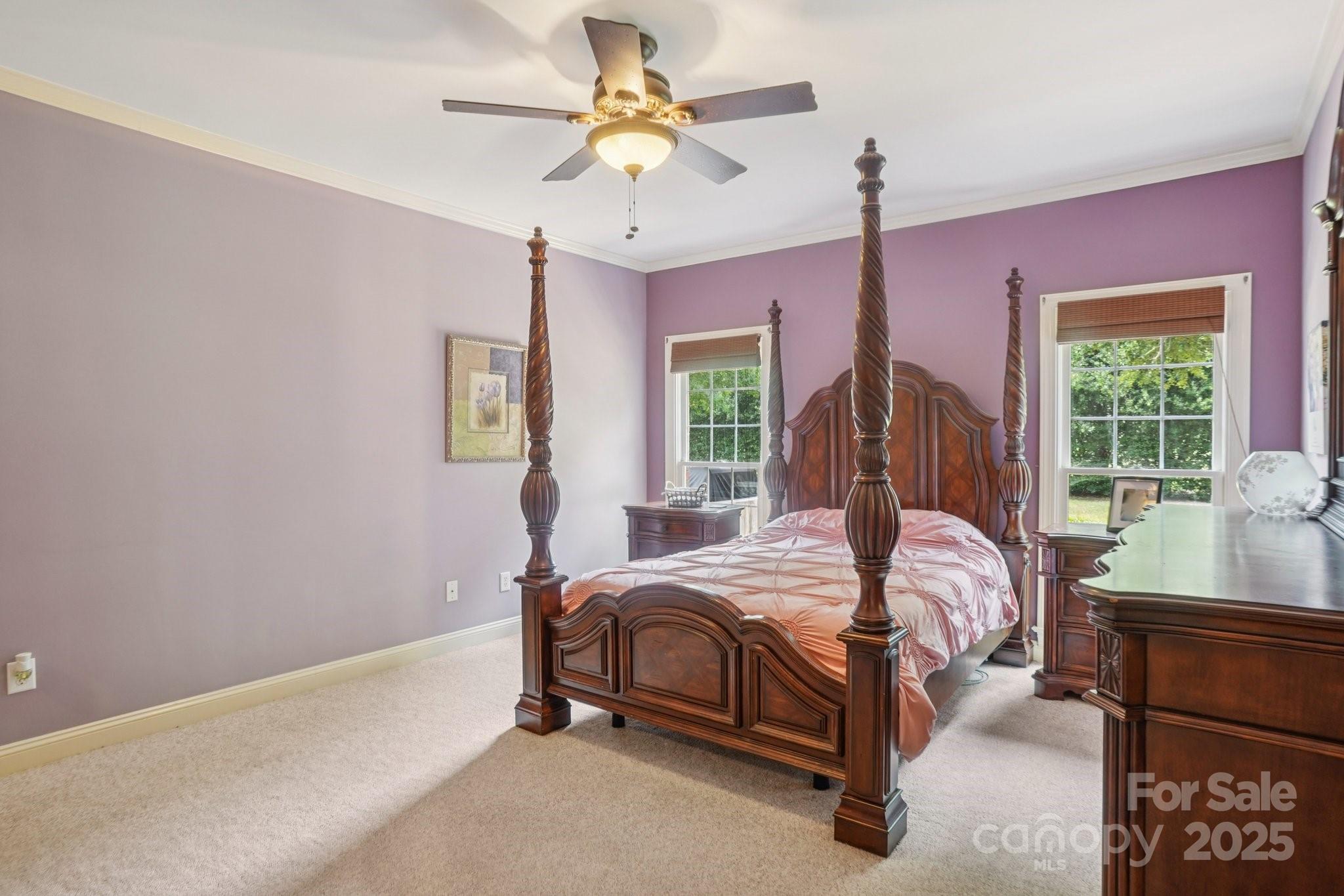 105 Berea Baptist Church Road Stanfield, NC 28163 - Photo 20 of 48 a bed room with a bed and a chandelier