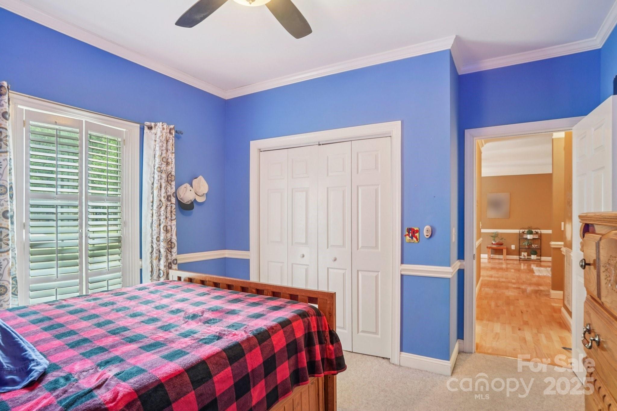 105 Berea Baptist Church Road Stanfield, NC 28163 - Photo 33 of 48 a bedroom with a bed and a chandelier