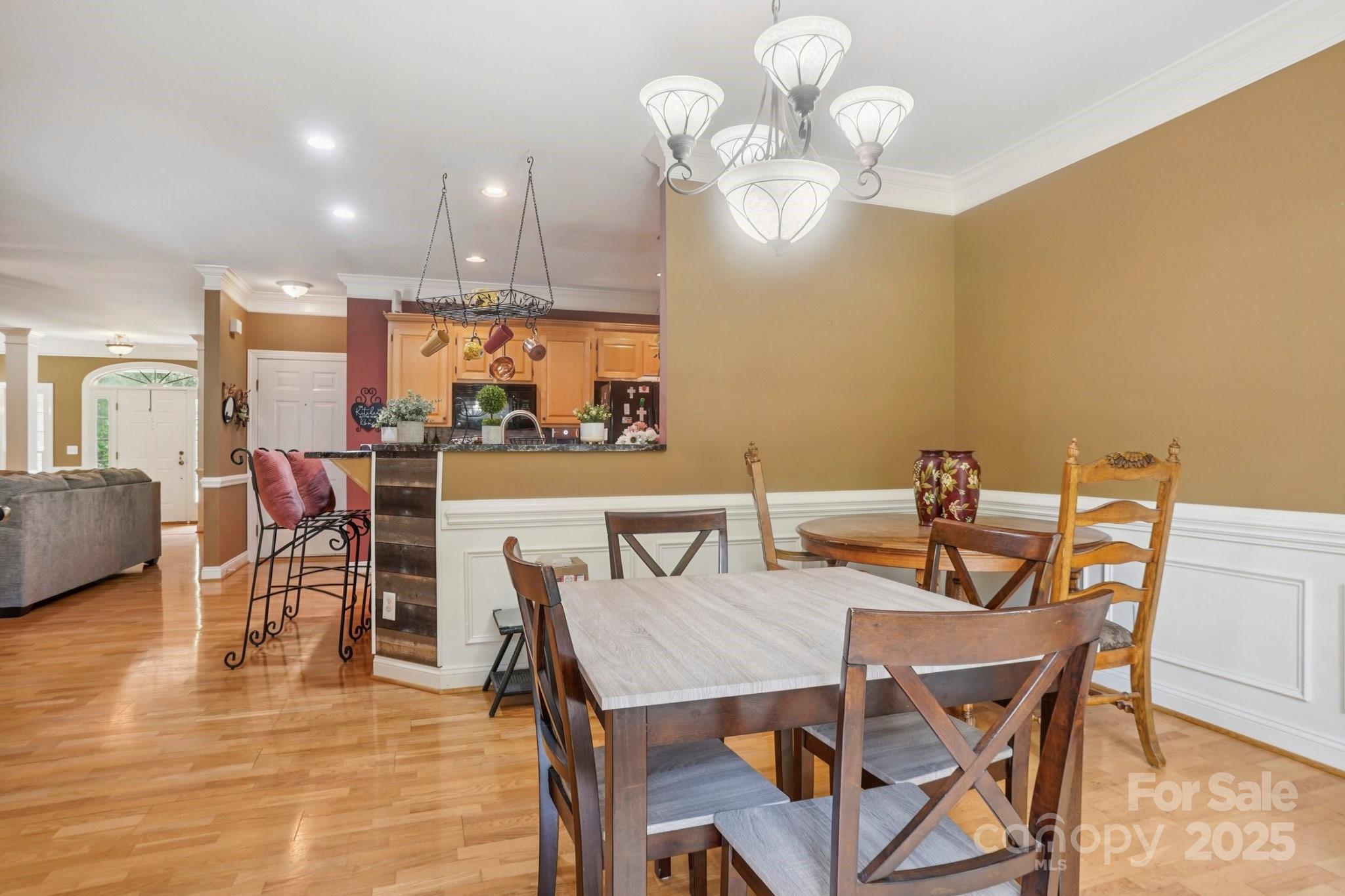 105 Berea Baptist Church Road Stanfield, NC 28163 - Photo 10 of 48 a view of a dining room with furniture and a chandelier