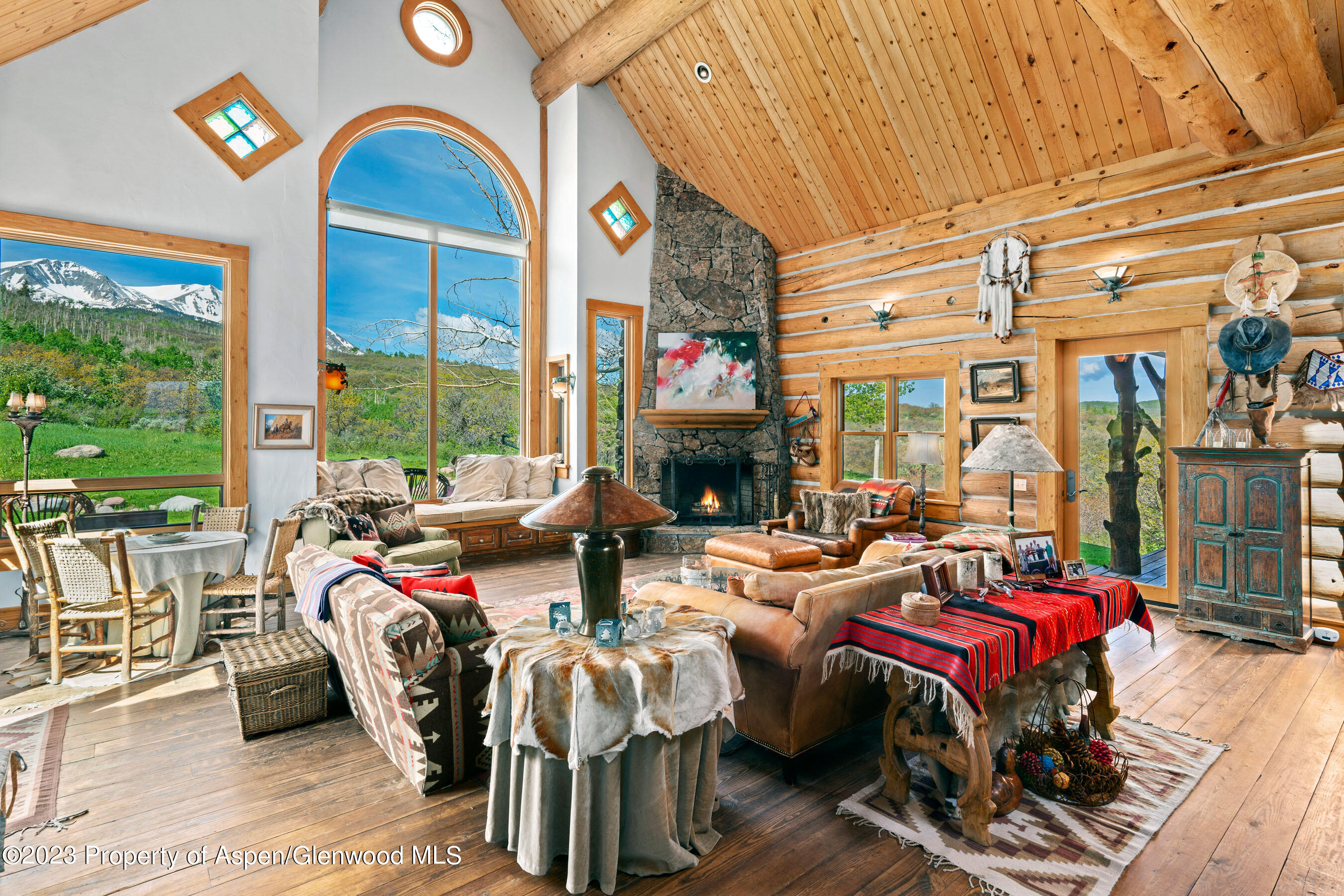 2088 Old Herron Road Basalt, CO 81621 - Photo 5 of 38 a living room with furniture a fireplace and large windows