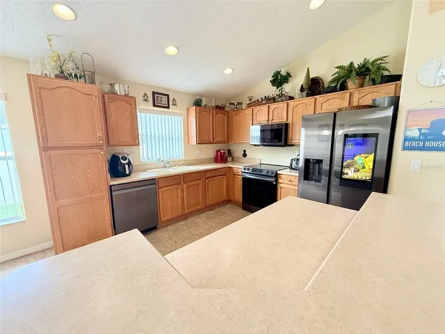a large white kitchen with a sink and cabinets