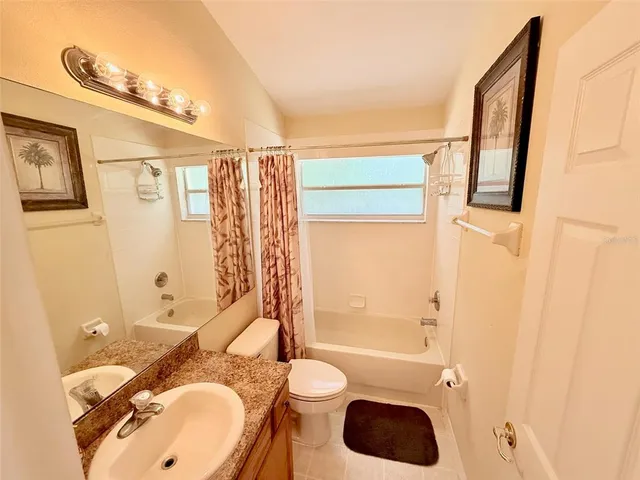 a bedroom with a bed dresser and a window