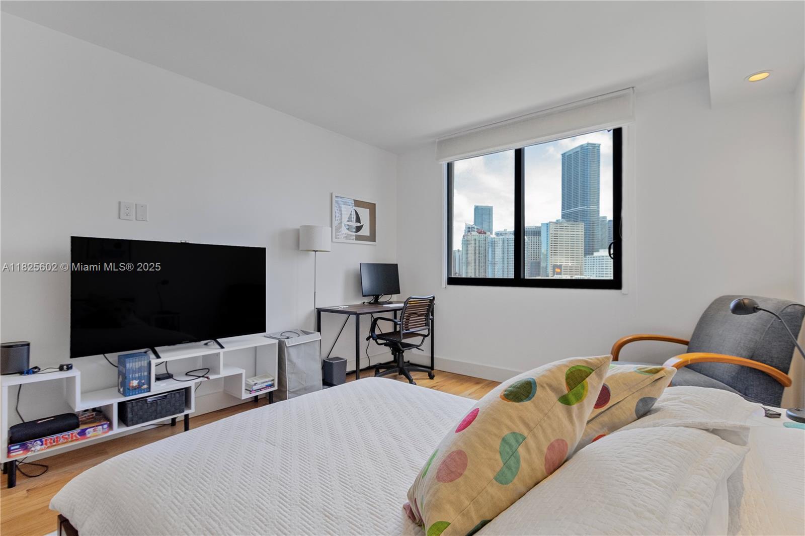 520 Brickell Key Drive, Unit A1421 Miami, FL 33131 - Photo 25 of 36 a bedroom with bed and a flat screen tv