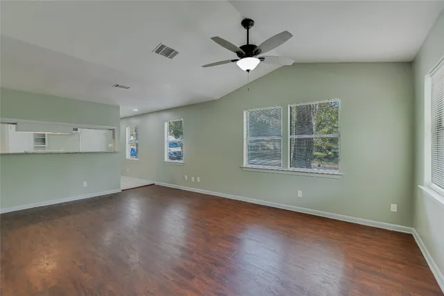 wooden floor in an empty room with a window