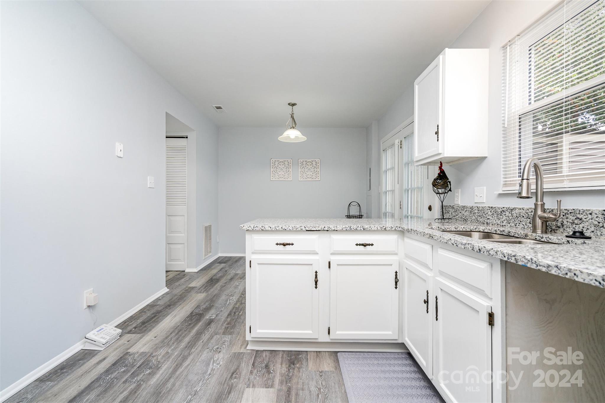 1101 Scaleybark Road, Unit B Charlotte, NC 28209 - Photo 7 of 18 a kitchen with a sink stove and cabinets