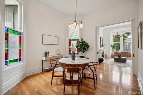 a view of a dining room with furniture and wooden floor