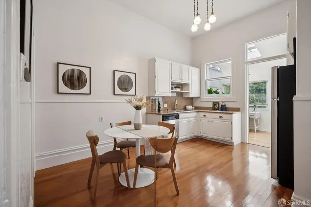 a kitchen with stainless steel appliances granite countertop a table and chairs
