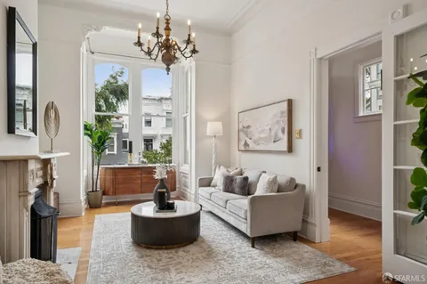 a living room with furniture and a chandelier