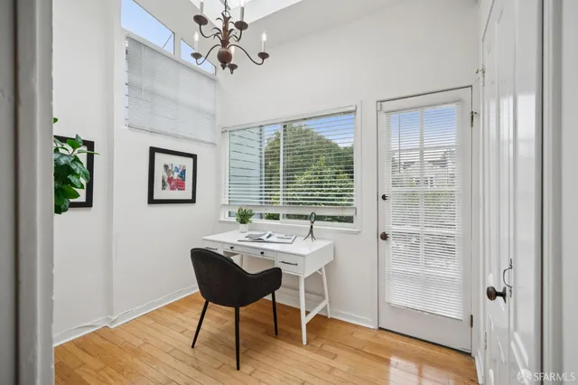 a view of a workspace with furniture and a potted plant