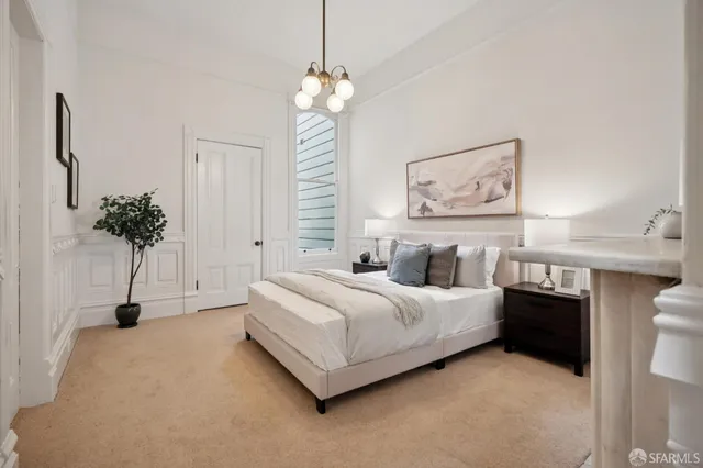 a bedroom with bed and a fireplace