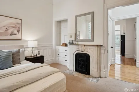 a spacious bedroom with a bed and a chandelier