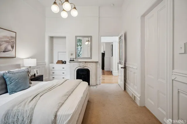 a bedroom with bed and a chandelier