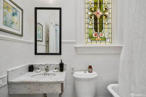 a bathroom with a sink toilet a mirror and shower