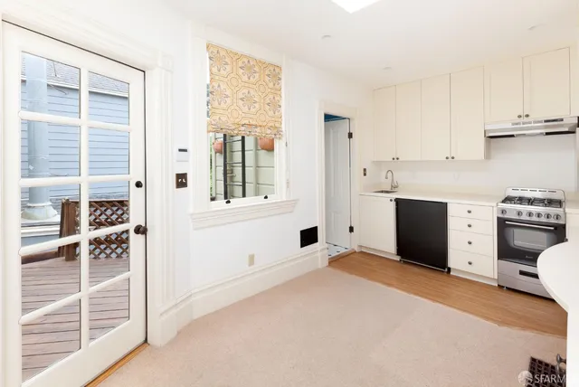 a view of an empty room with a kitchen