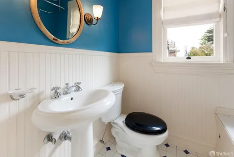 a backyard of a house with potted plants and large tree