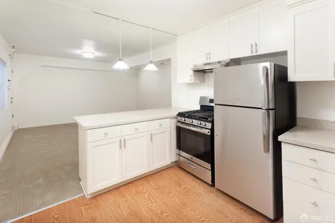 a kitchen with appliances cabinets and a sink
