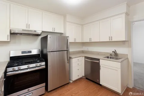 a bathroom with a sink toilet vanity and shower