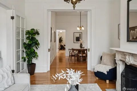 a view of a dining room with furniture wooden floor and a chandelier