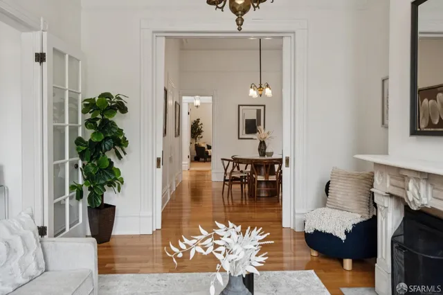 a view of a dining room with furniture wooden floor and a chandelier