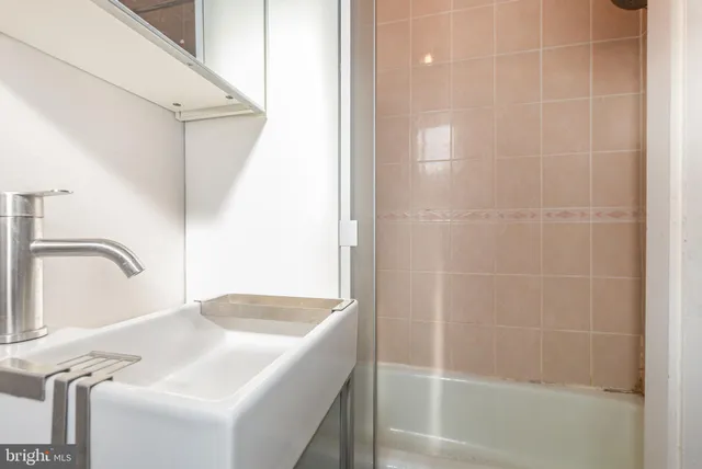 a bathroom with a sink and shower