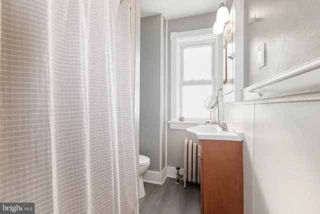a kitchen with a sink a refrigerator and a window