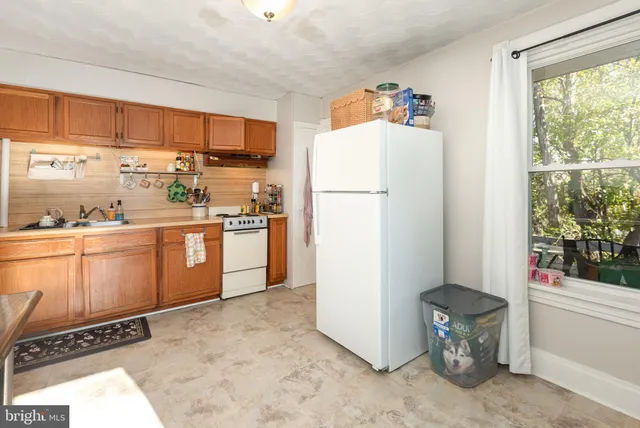 a bedroom with a bed and a tv on the dresser