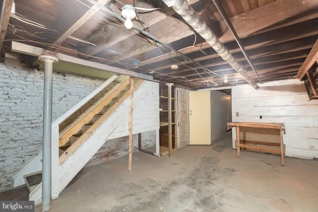 a front view of a house with a tree in front