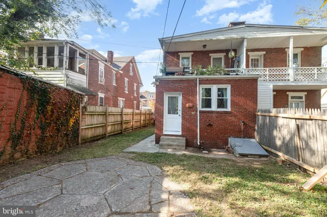 a view of a chairs and car parked on the road