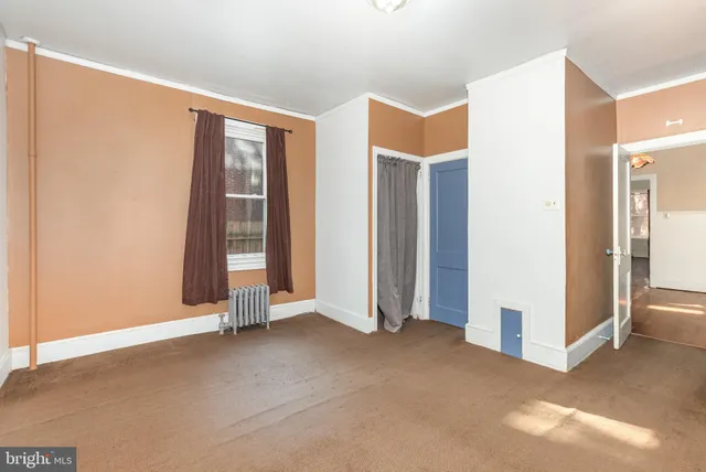 a view of an empty room with closet area