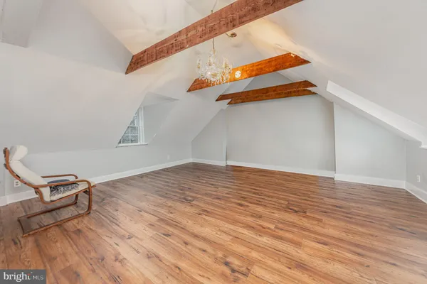 a view of a room with wooden floor and windows