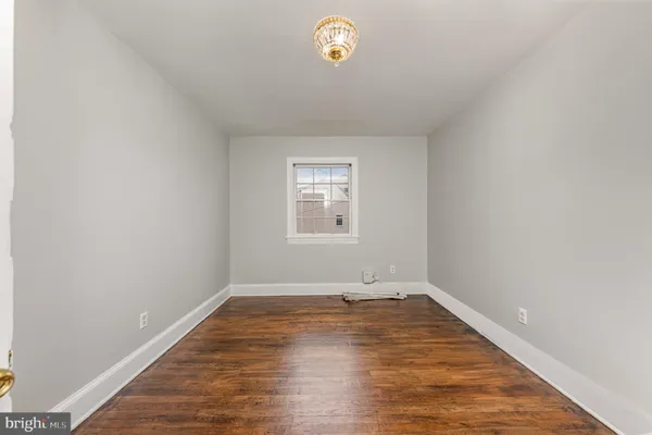 a view of empty room with window and ceiling fan
