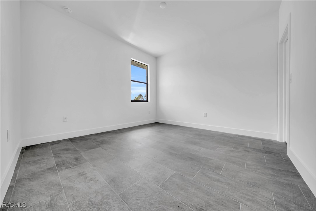 3224 53rd Street West Lehigh Acres, FL 33971 - Photo 11 of 14 an empty room with a workbench