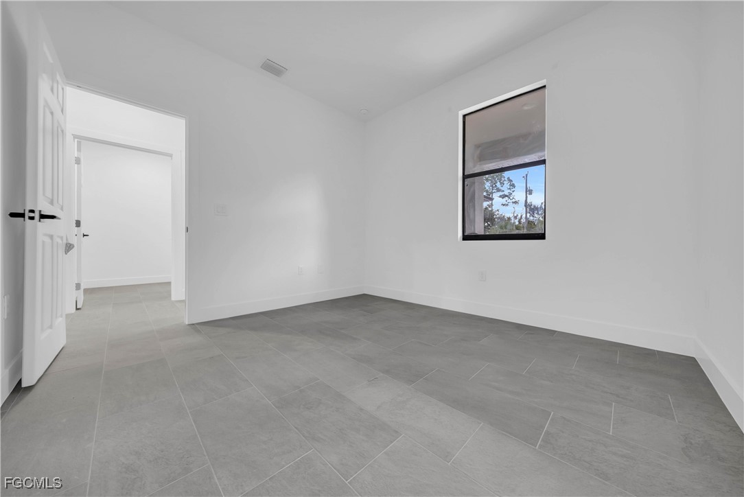 3224 53rd Street West Lehigh Acres, FL 33971 - Photo 17 of 22 a view of an empty room with a painting