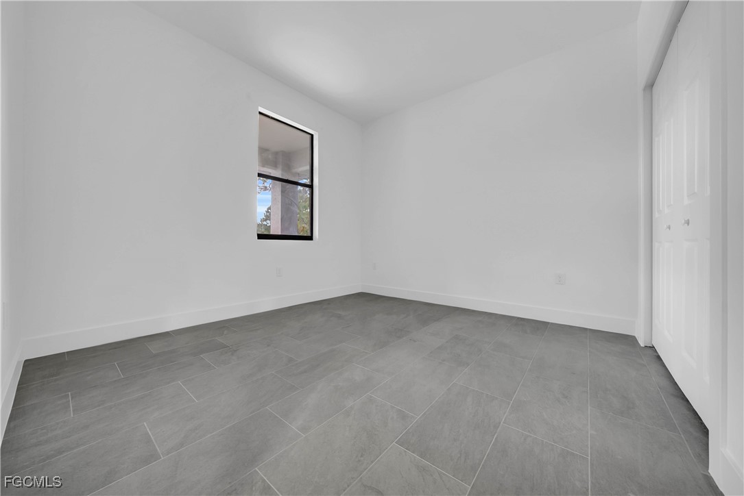 3224 53rd Street West Lehigh Acres, FL 33971 - Photo 18 of 22 an empty room with a window