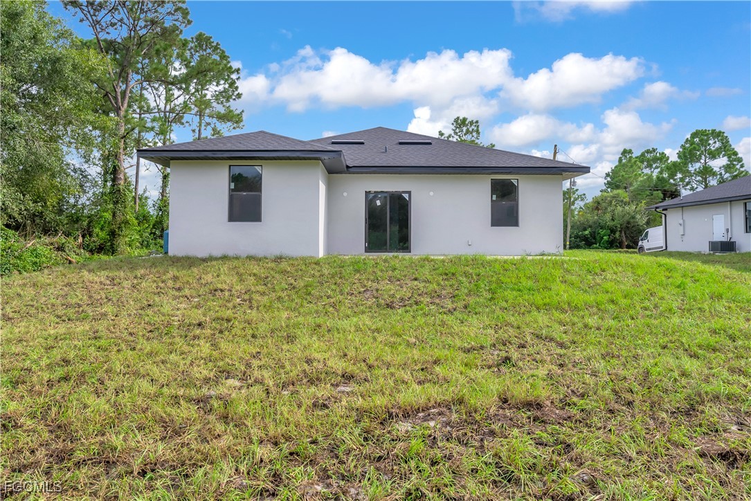3224 53rd Street West Lehigh Acres, FL 33971 - Photo 20 of 22 a view of a house with yard and a garden
