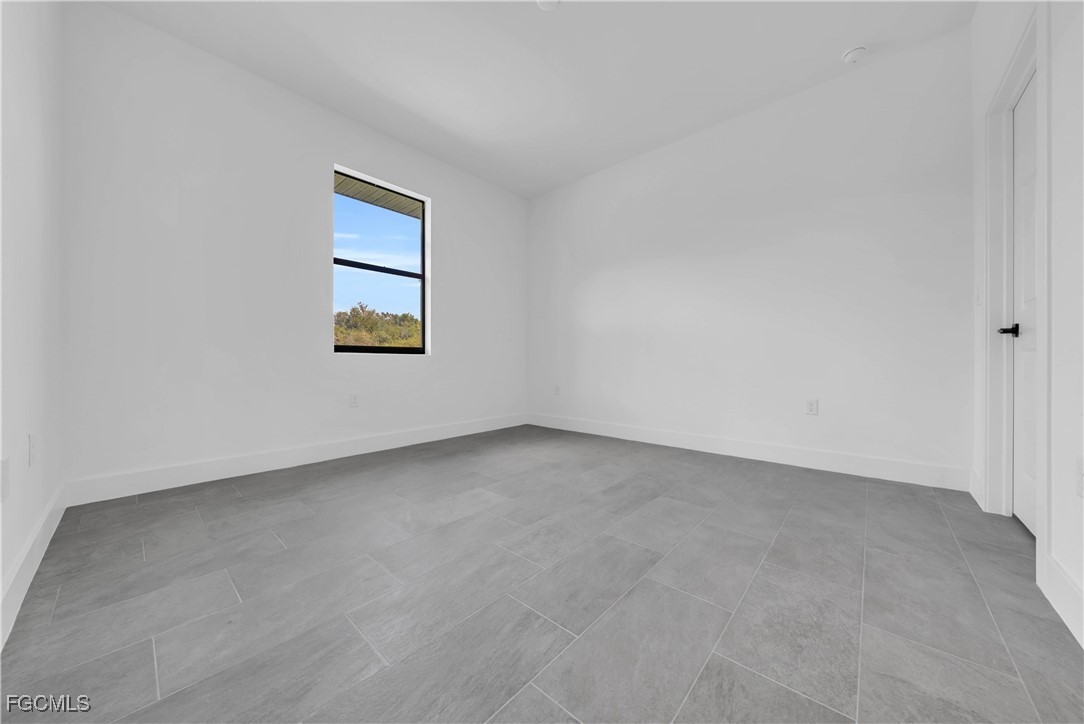 3224 53rd Street West Lehigh Acres, FL 33971 - Photo 8 of 14 an empty room with a window