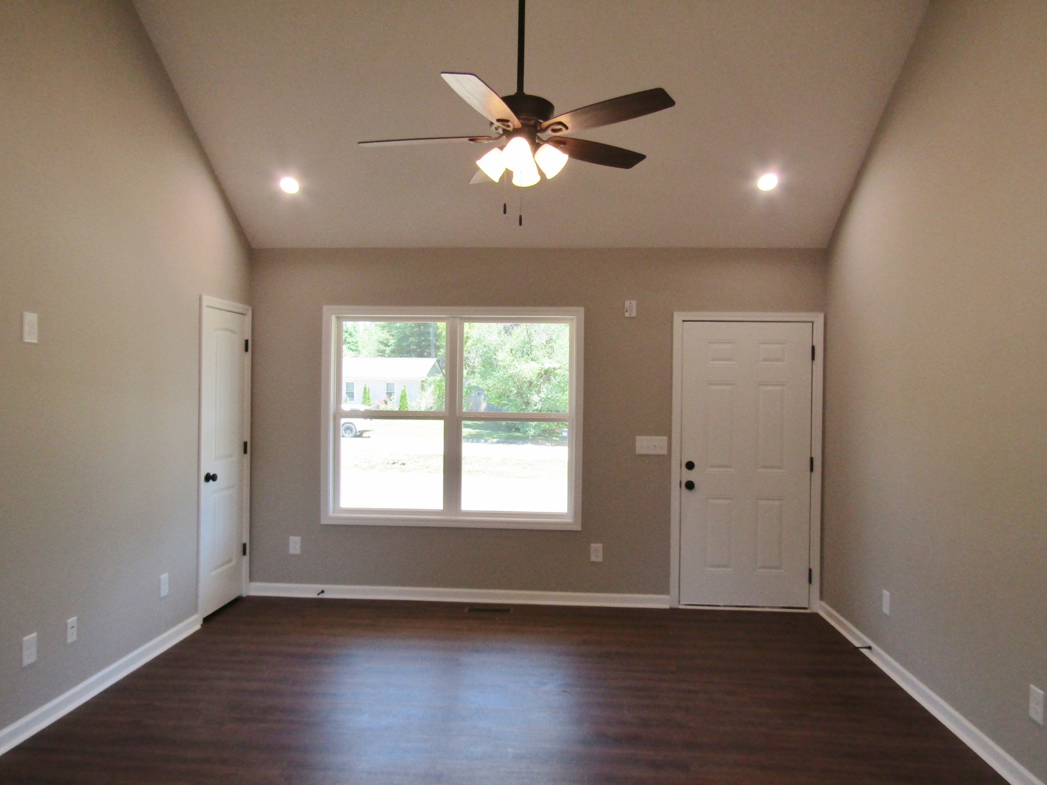 460 Crescent Factory Road Lawrenceburg, TN 38464 - Photo 3 of 13 a view of an empty room with wooden floor and a window