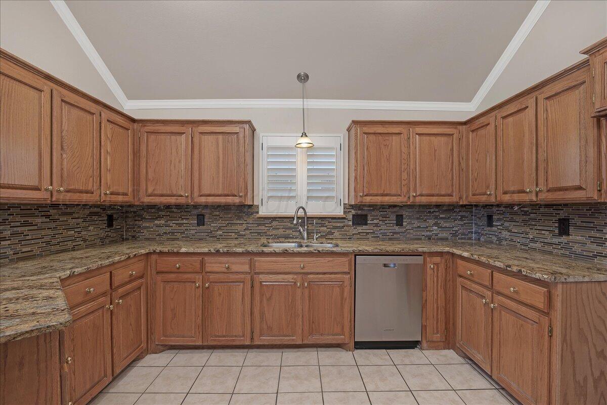 5823 Nicholas Circle Amarillo, TX 79109 - Photo 11 of 31 a kitchen with a sink stove and cabinets