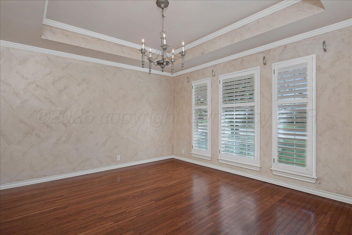 5823 Nicholas Circle Amarillo, TX 79109 - Photo 13 of 31 wooden floor in an empty room with a window