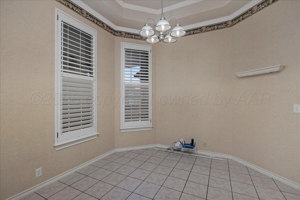 5823 Nicholas Circle Amarillo, TX 79109 - Photo 14 of 31 a view of an empty room with window and chandelier fan