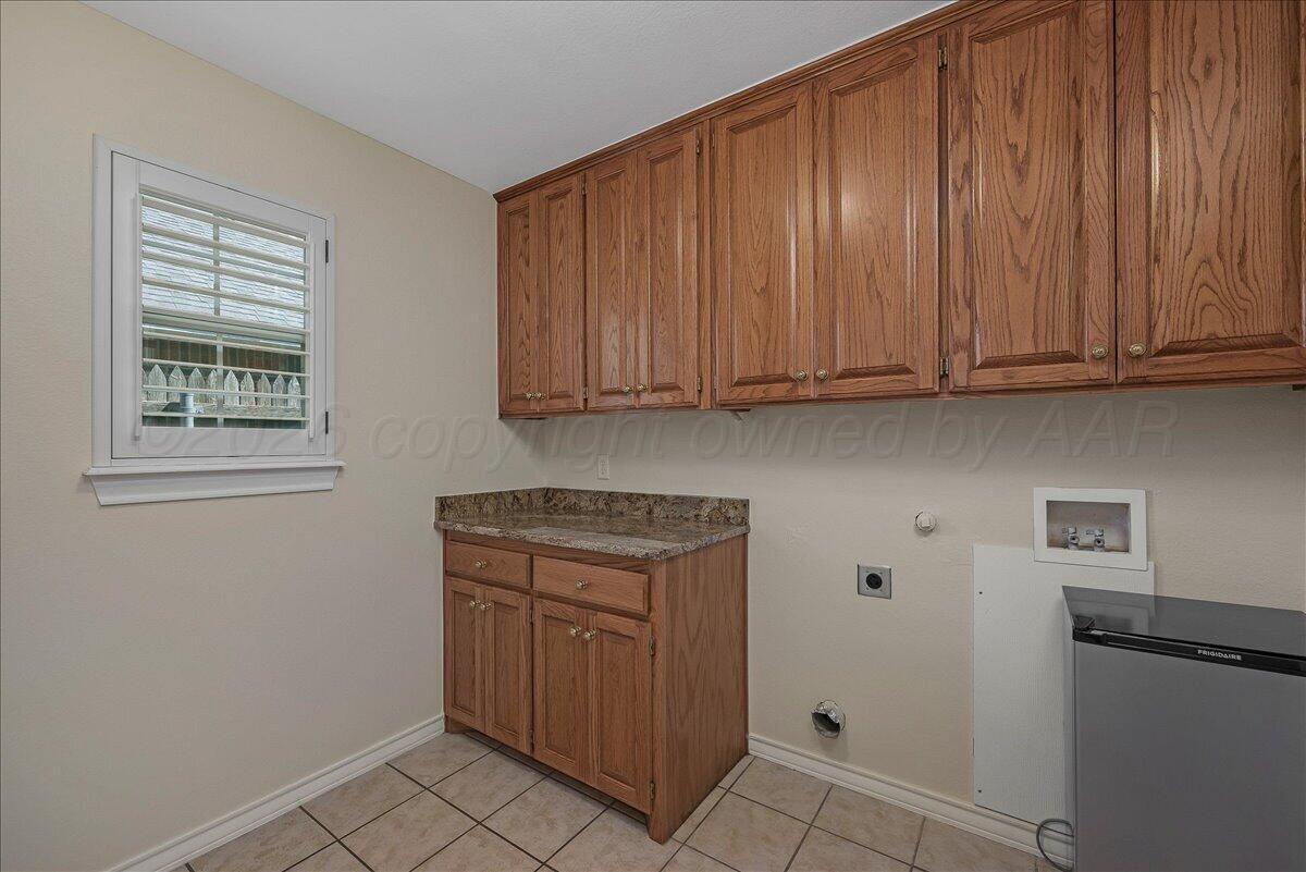 5823 Nicholas Circle Amarillo, TX 79109 - Photo 26 of 31 a kitchen with granite countertop cabinets and window