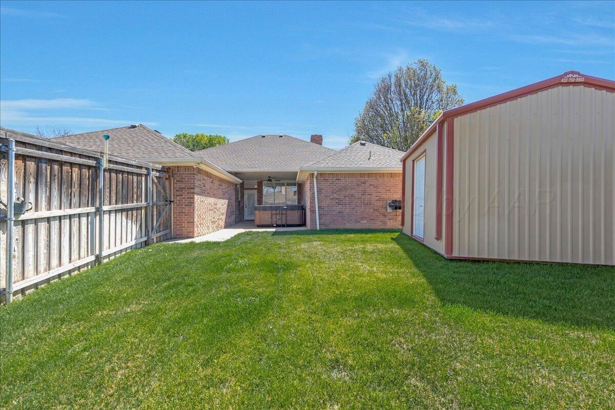 5823 Nicholas Circle Amarillo, TX 79109 - Photo 29 of 31 a view of a house with a backyard and a window